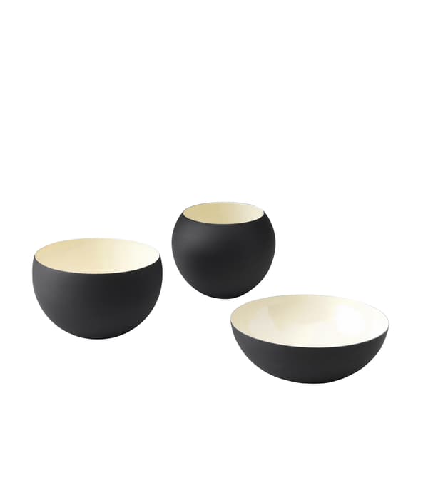 Three black and ivory bowls in different shapes and sizes.