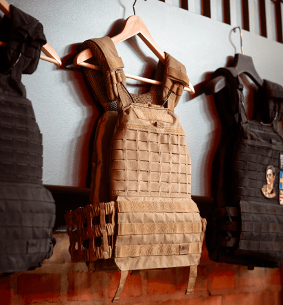 Three body vests for practising combat hung on a wall.