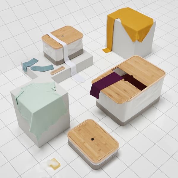 Three boxes in different sizes on a white tiled floor.