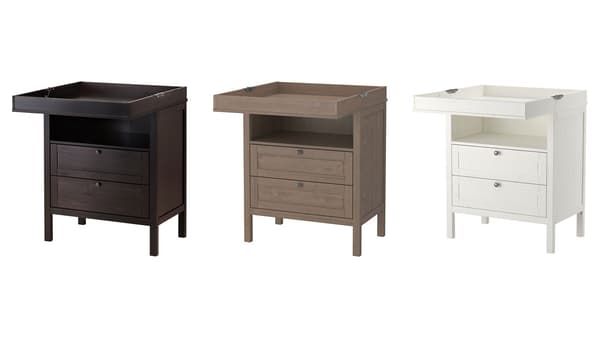 Three changing tables with storage in black-brown, gray-brown, and white all against a white background.