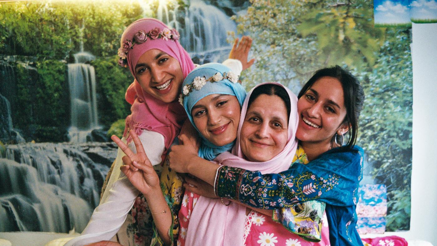 Three confident women posing at the fabrics department of an IKEA store in honor of World Refugee Day on June 20th.