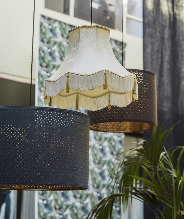 Three mismatched pendant lamps hanging at different heights.