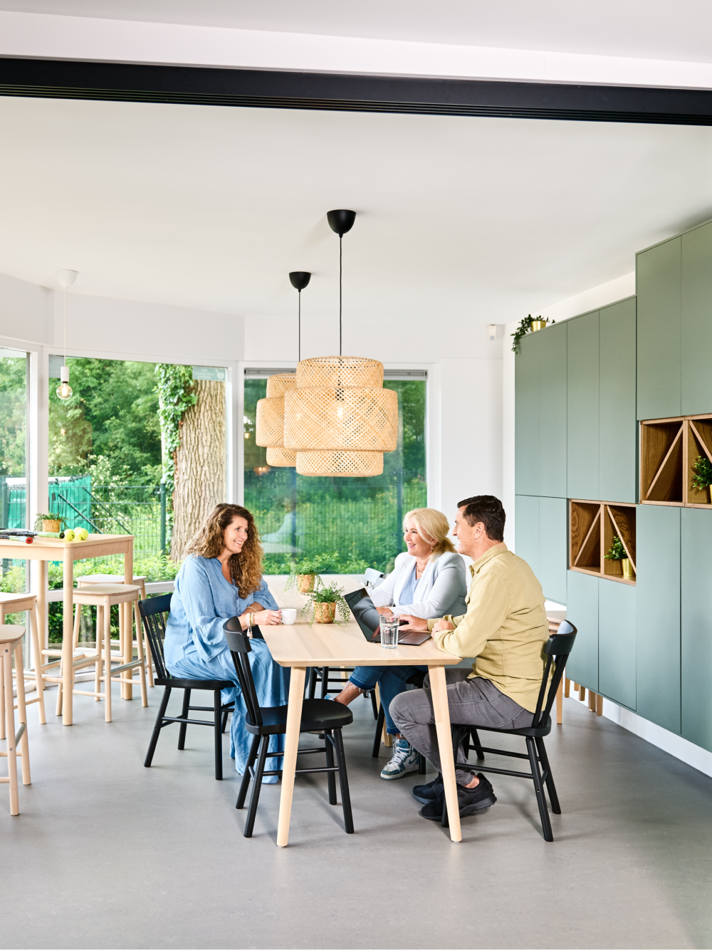 Three people having a pleasant conversation at the table