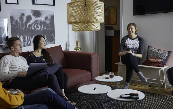 Three people having coffee in a living room.