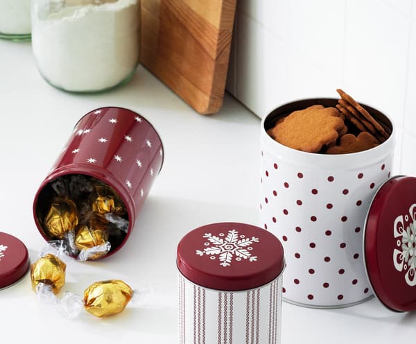 Three-tier VINTERFEST serving stand on a table with savouries and sweet cakes.
