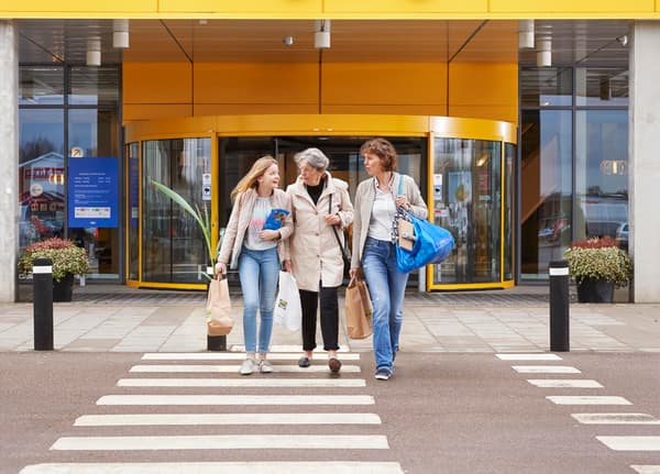 Three women walking out of an ikea store