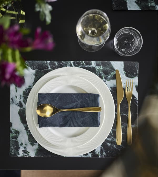 TILLAGD cutlery in brass-coloured, metallisted stainless steel at a modern table setting.