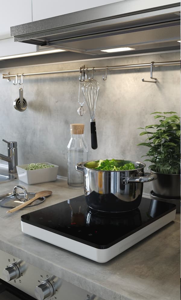 TILLREDA induction hob sits on a kitchen top with stewed veg. 