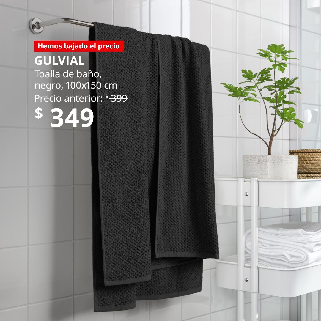 Toalla de baño GULVIAL color negro colgada en un toallero en un baño.