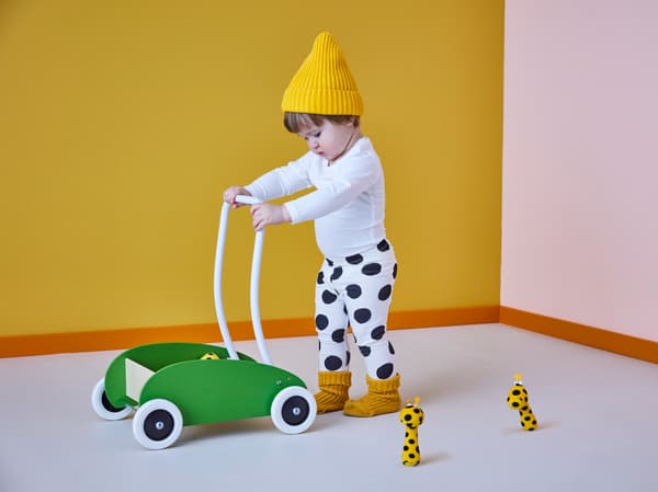 Toddler walking a MULA toddle truck.