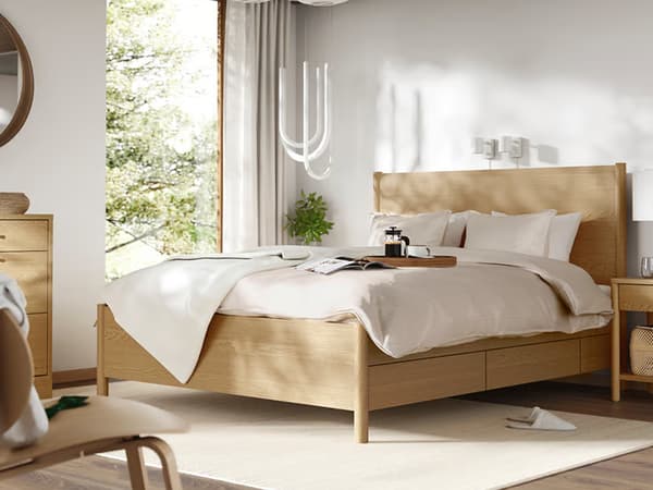 TONSTAD bedframe in bedroom setting with a bedside table. 