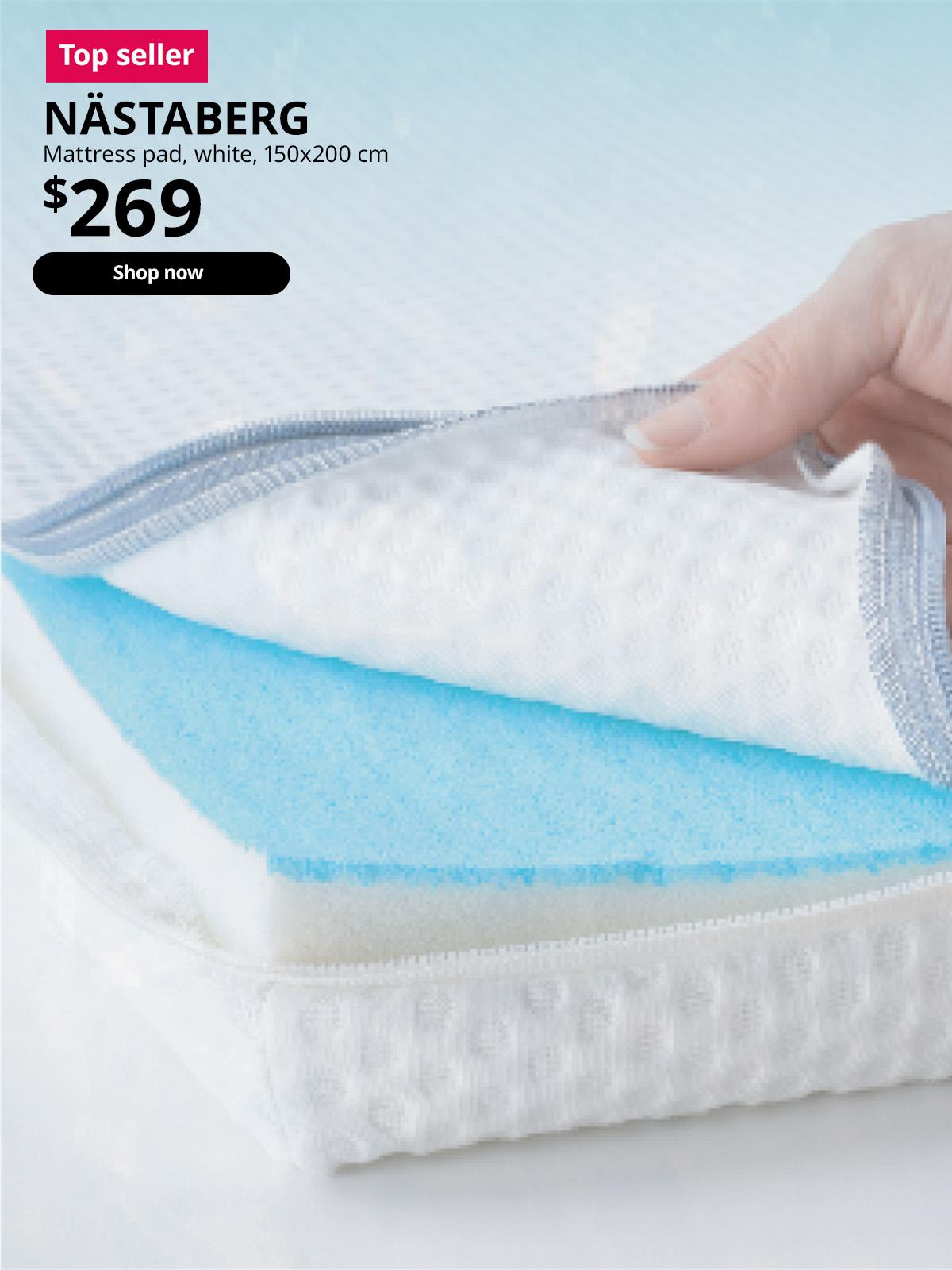 Top seller product in IKEA's cooling range. NÄSTABERG mattress pad, white, 150x200 cm. A hand peels open the unzipped mattress pad to reveal a cooling layer. Price: $269.