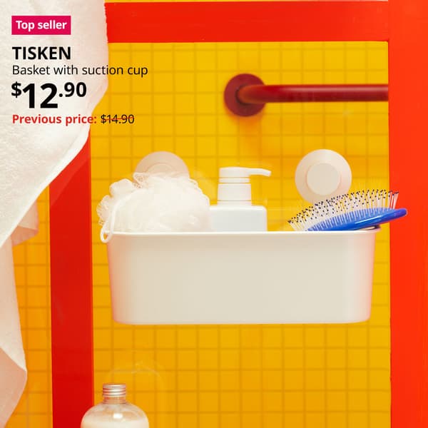 Top seller tag. A white TISKEN basket with suction is placed on the glass panel in the shower area with soap bottle, and other bathroom essentials items. Price: $12.90. Previous price slash $14.90.