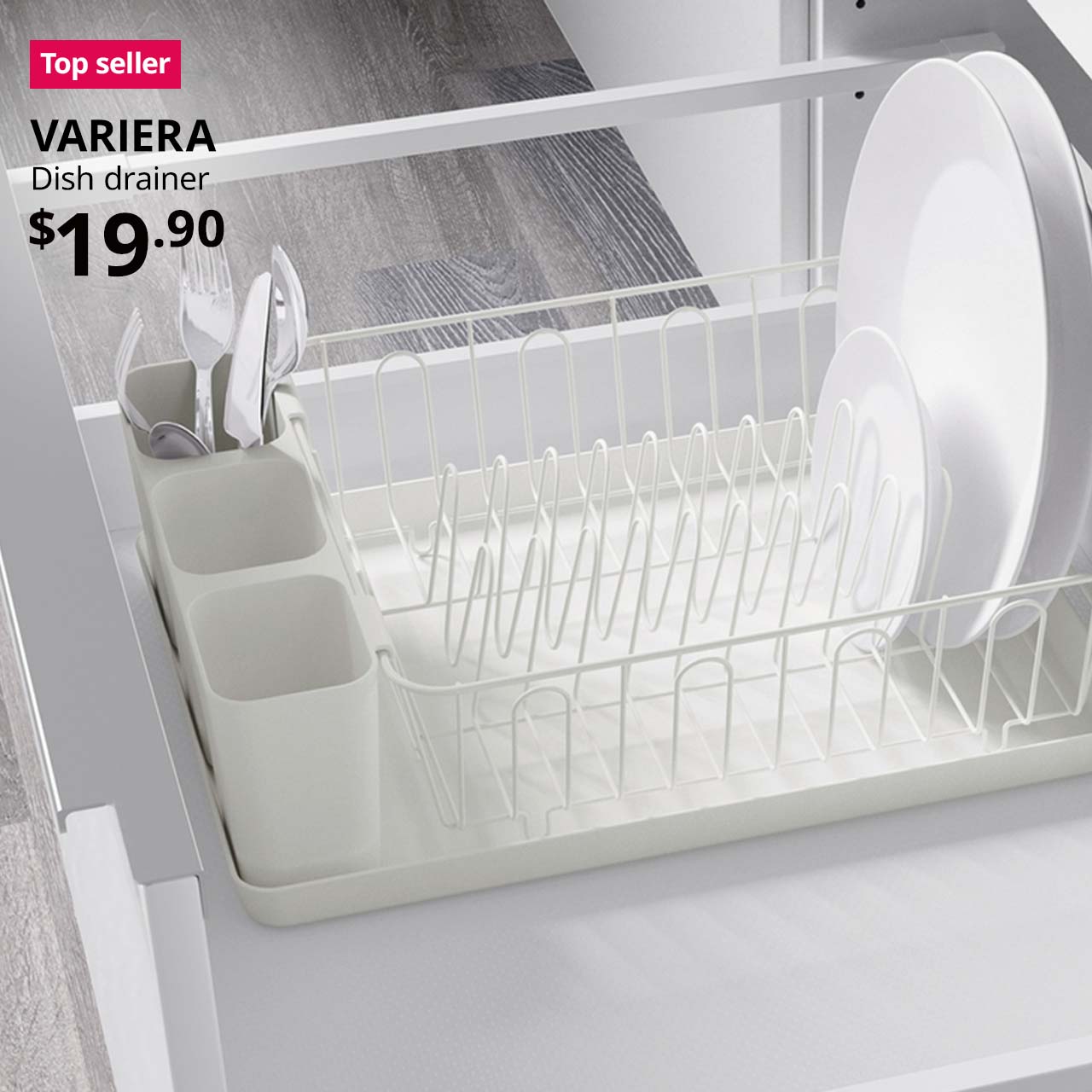 Top seller tag. VARIERA dish drainer placed within a kitchen shelving unit, with a bunch of utensils and white plates placed within the drainer. $19.90.