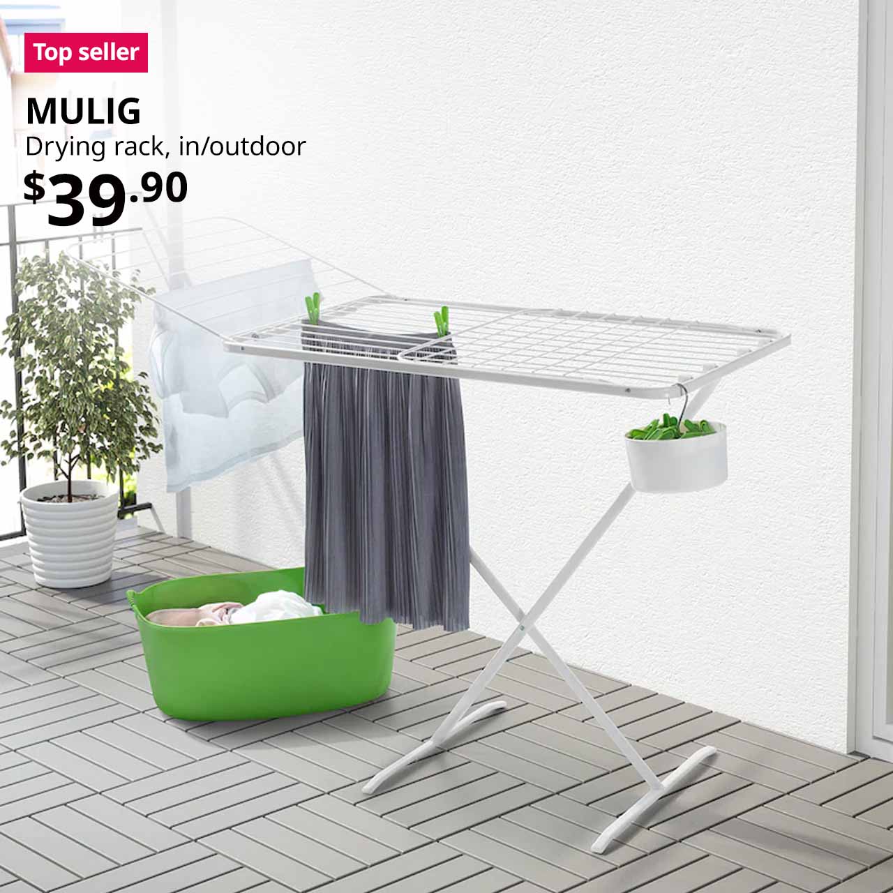 Top seller tag. White MULIG drying rack, placed outdoors in service yard laundry area with TORKIS laundry basket and SLIBB hanging pegs. Price: $39.90.