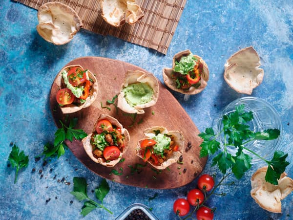 Tortilla Muffins werden mit Tomate & Avocado befüllt.