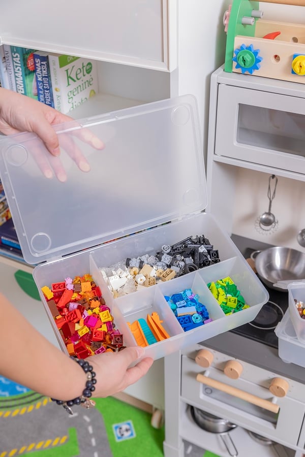 Transparent storage box with sorted LEGO bricks by color.