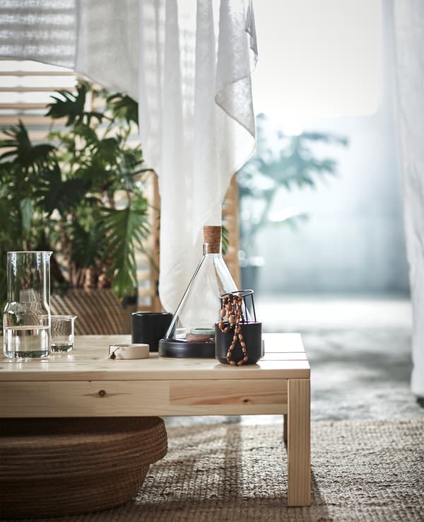 Trinkets and a glass cone on a wooden bench.