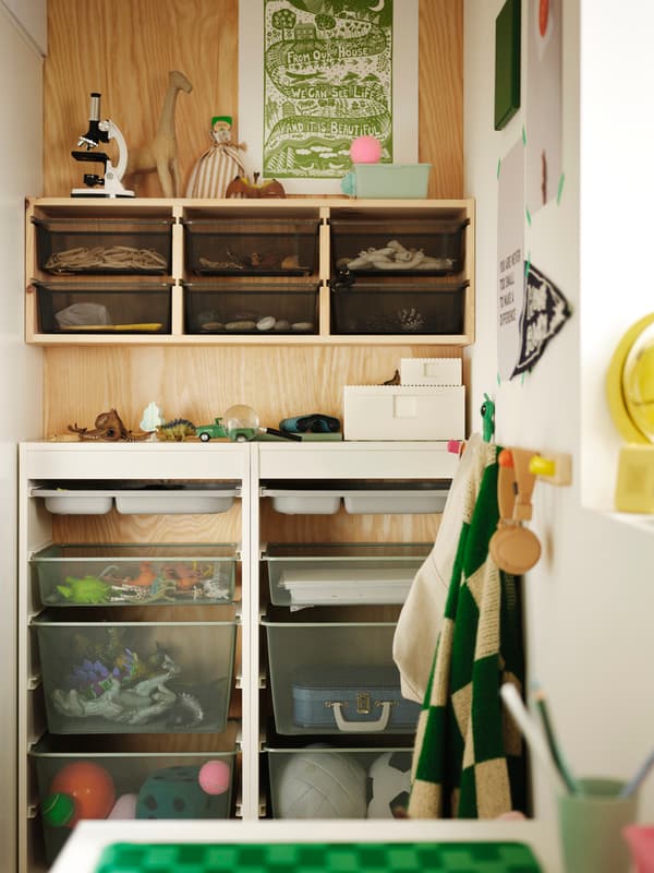 TROFAST storage boxes and trays are inserted into birch-coloured TROFAST wall shelf and white TROFAST frames.