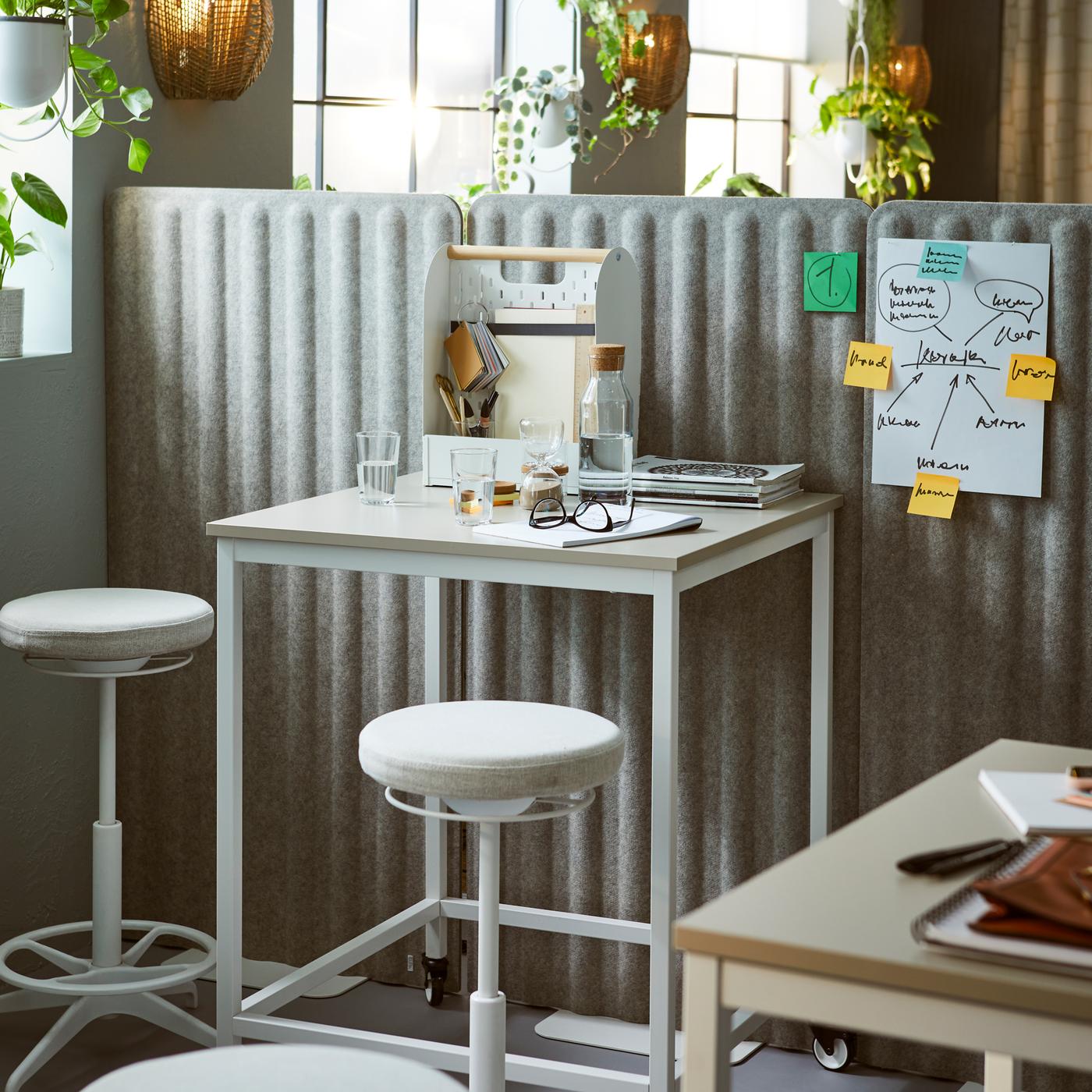 TROTTEN tables and LIDKULLEN active sit-stand supports placed next to a room divider formed by EILIF free-standing screens.