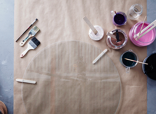 Turn VITTSJÖ coffee table from IKEA into a painted glass-top table by splattering the underside of the glass with colourful paint. Let it dry and then roll on a layer of black paint to match the table’s black-brown legs and lower shelf. 