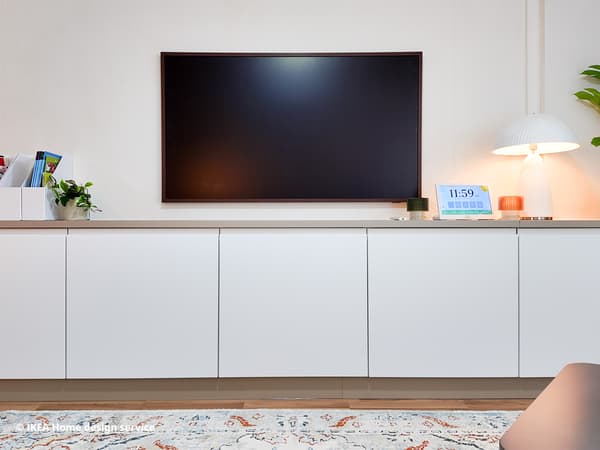 TV mounted on wall above brown and white METOD modular storage in a living room in Singapore, designed by IKEA Home design service