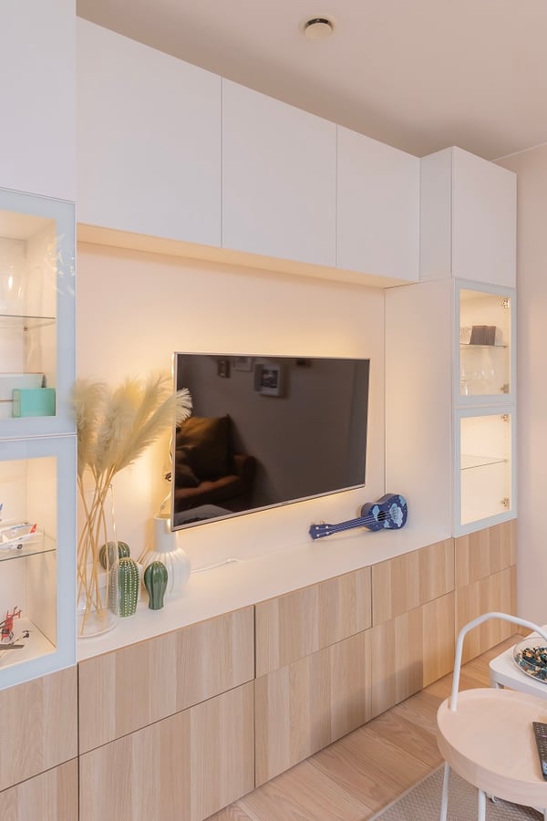 TV wall unit with cabinets, display shelves, and home decor.