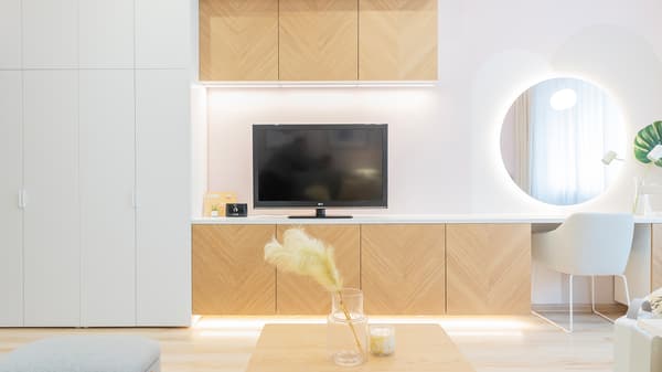 TV wall unit with storage cabinets and modern lighting