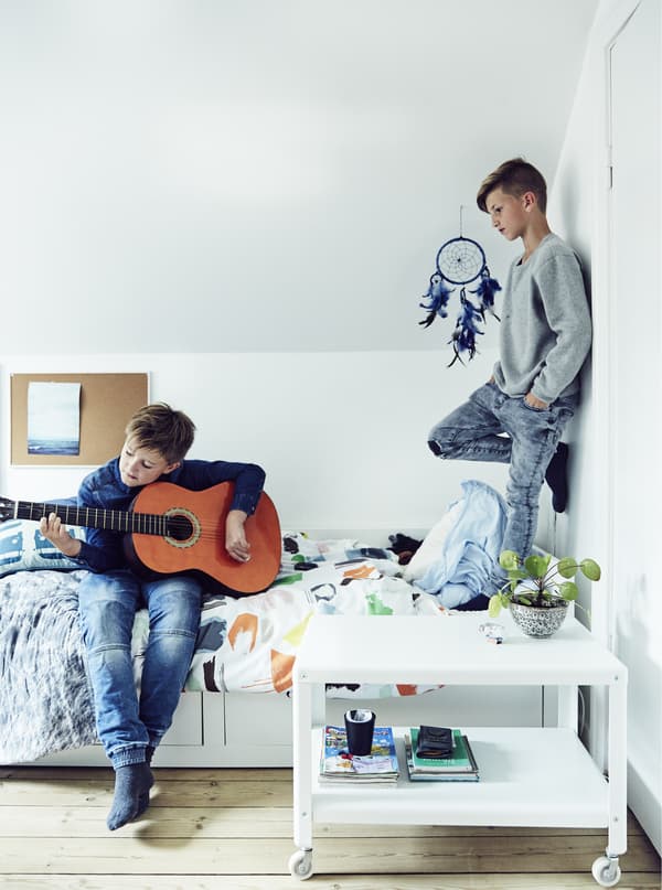 Two boys playing in a child’s bedroom.