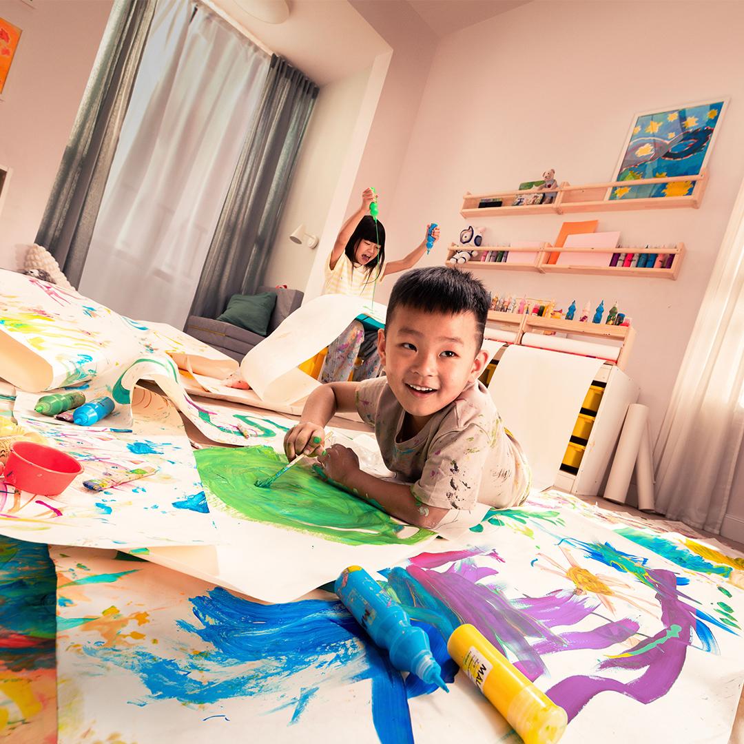 Two children are playing with paint