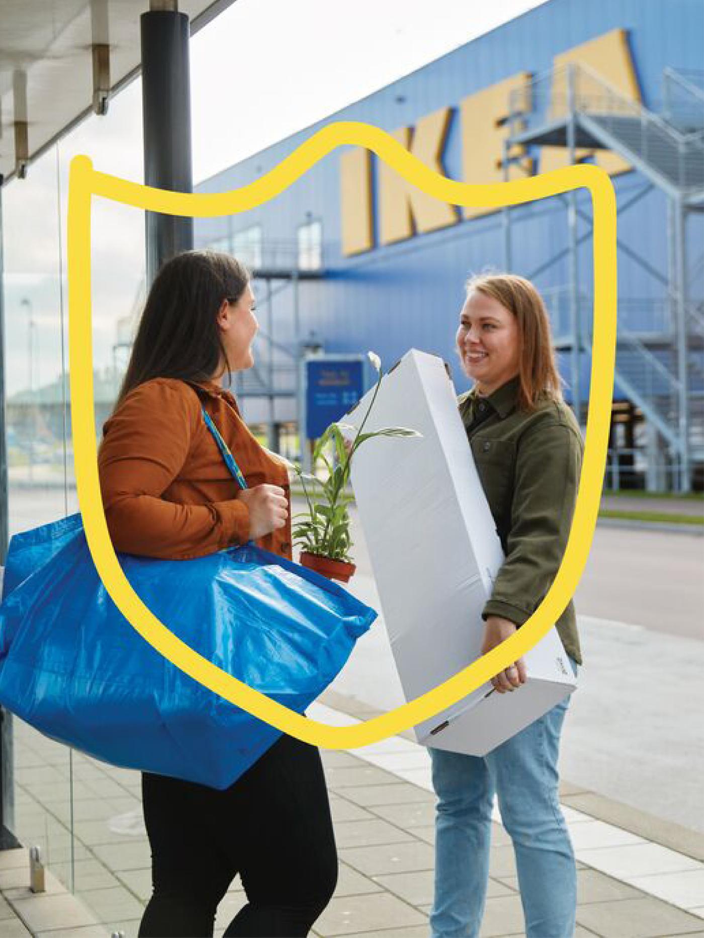 Two customers outside of an IKEA store chatting