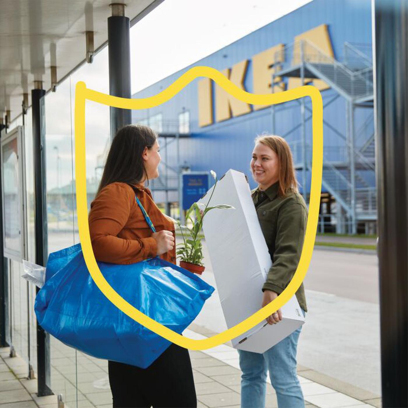 Two customers outside of an IKEA store chatting