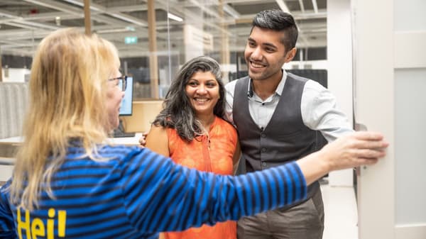 Two customers plan a wardrobe together with an IKEA co-worker.
