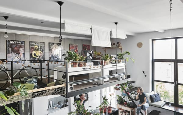 Two desks and plants on a mezzanine level.