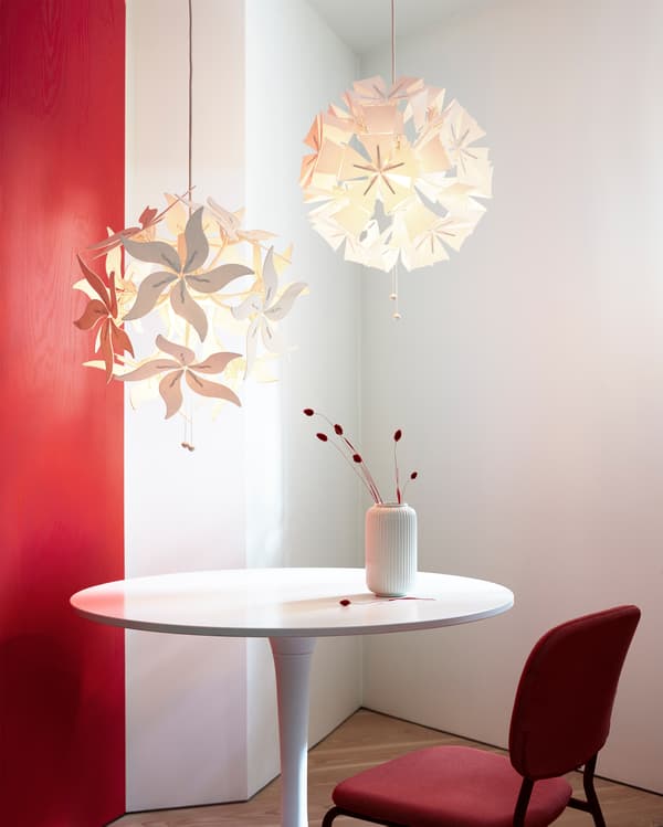 Two different RAMSELE pendant lamps in a flower or geometric shape that can unfold when the strings are pulled.