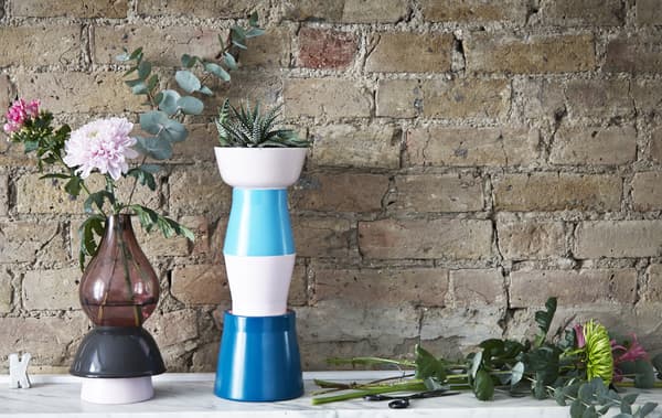 Two DIY plant stands displaying plants and flowers.