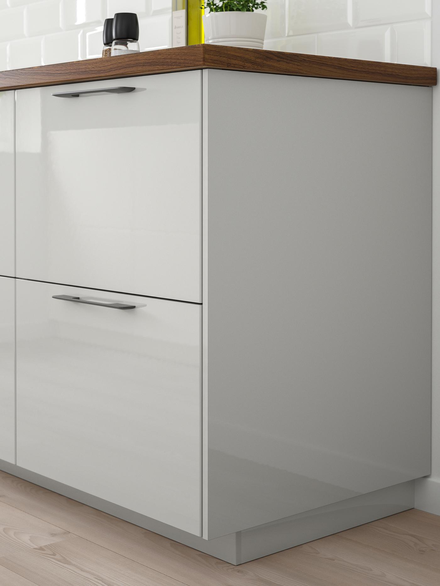Two drawers with RINGHULT high-gloss light-grey drawer fronts with stainless steel handles below a wooden worktop.