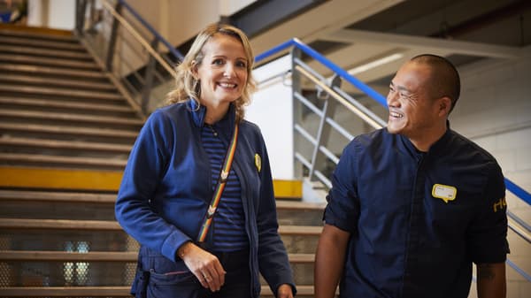 two IKEA co-workers smiling