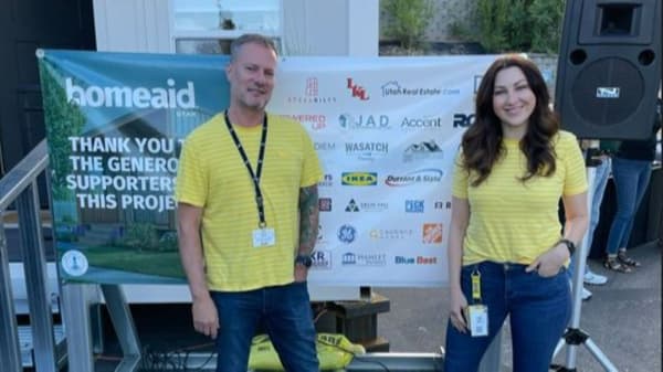 two IKEA Co-workers standing in front of the HomeAide tiny home
