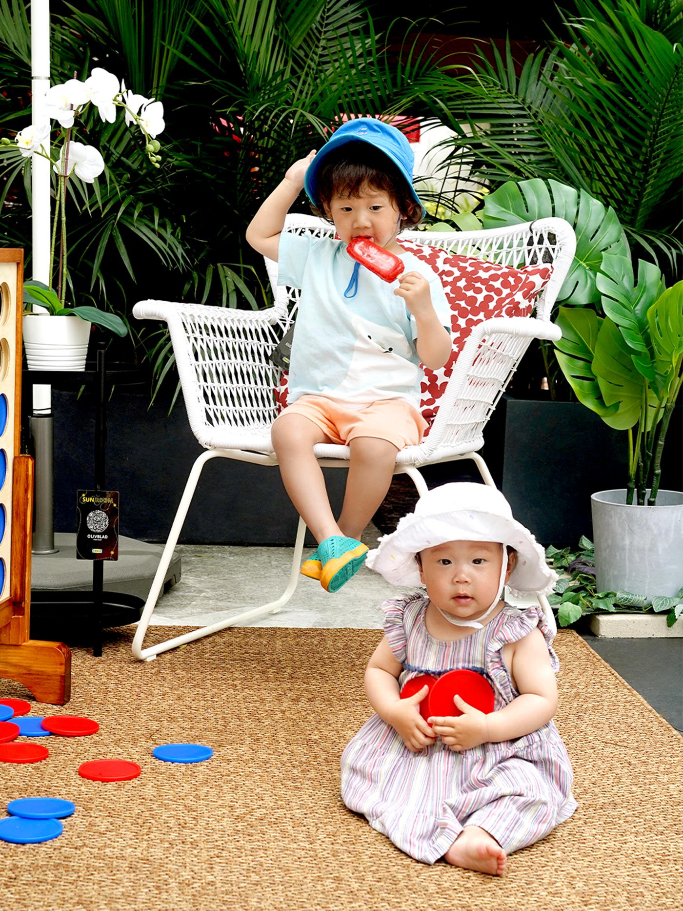 Two kids sitting on a patio