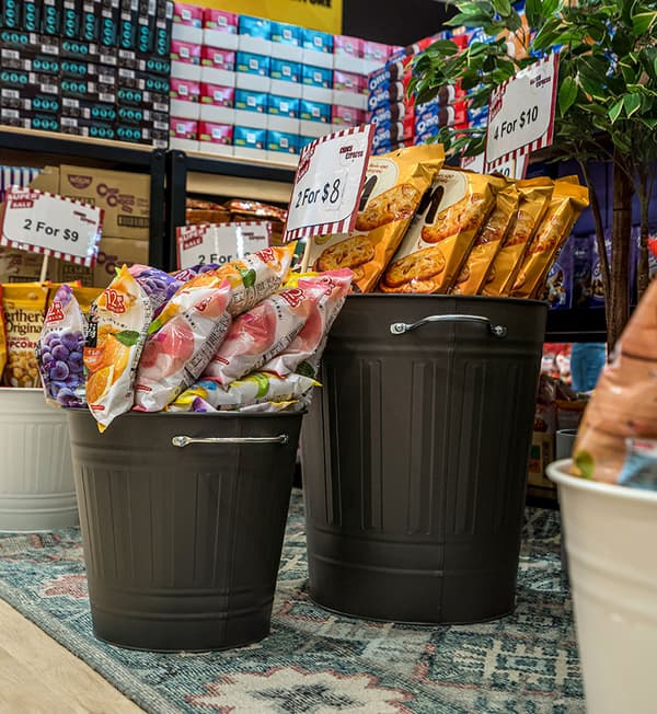 Two KNODD bins filled with products are displayed on a blue decorative carpet.