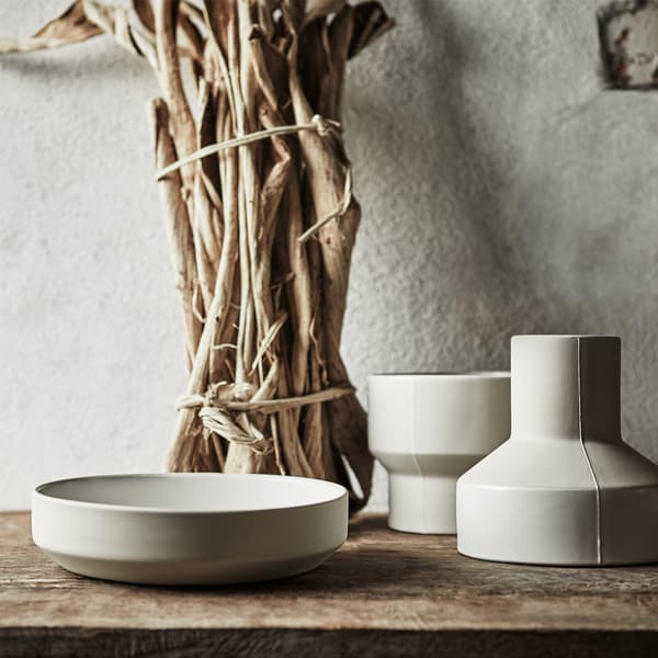 Two light grey, handmade ceramic vases and a wide, low bowl from the IKEA HANTVERK collection.