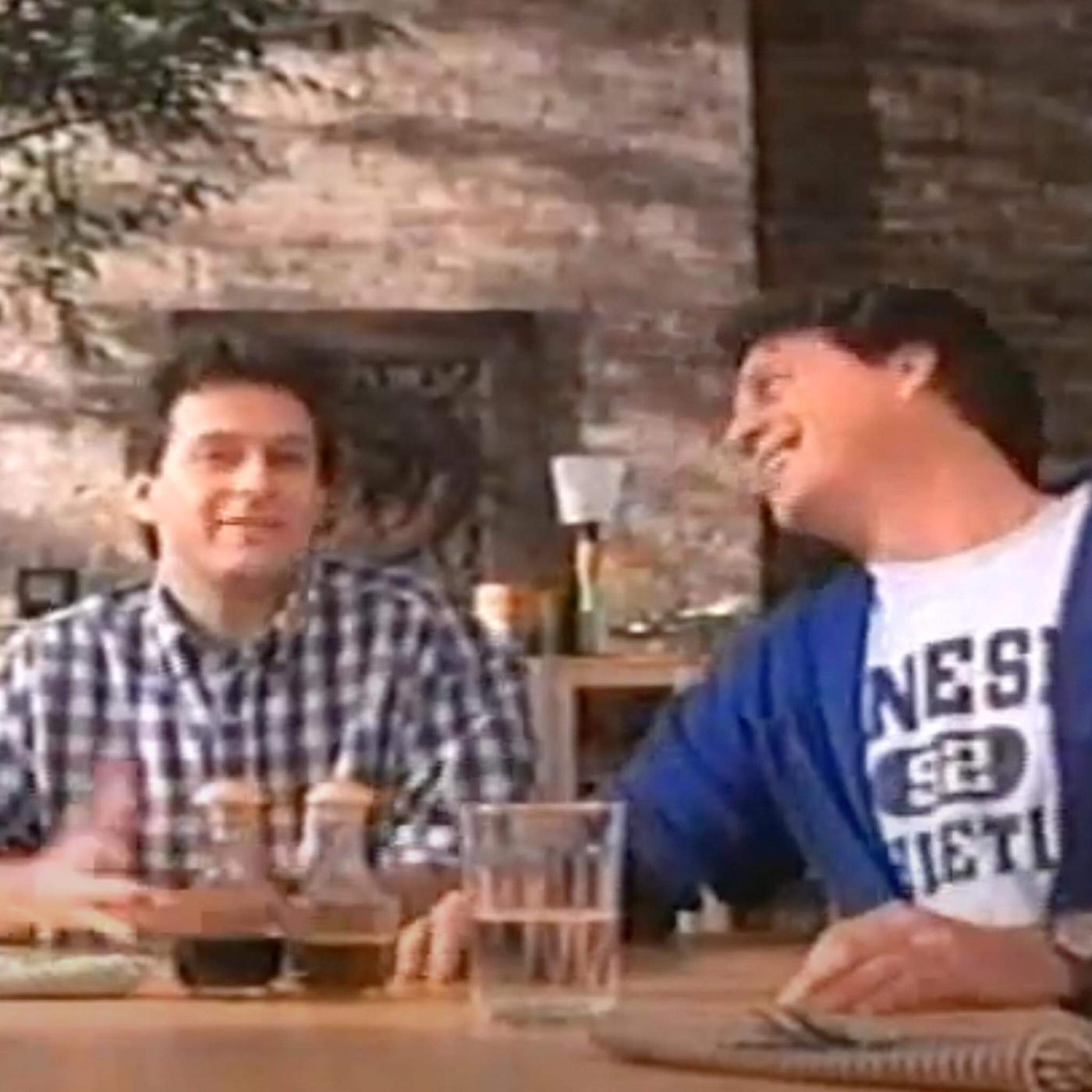 two men talking at table