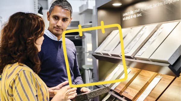Two people are checking a counter top.