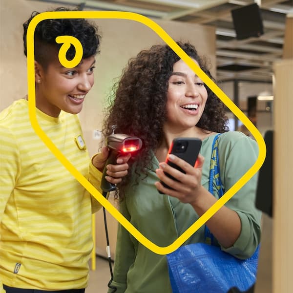 Two people are standing and scanning a receipt in a store.