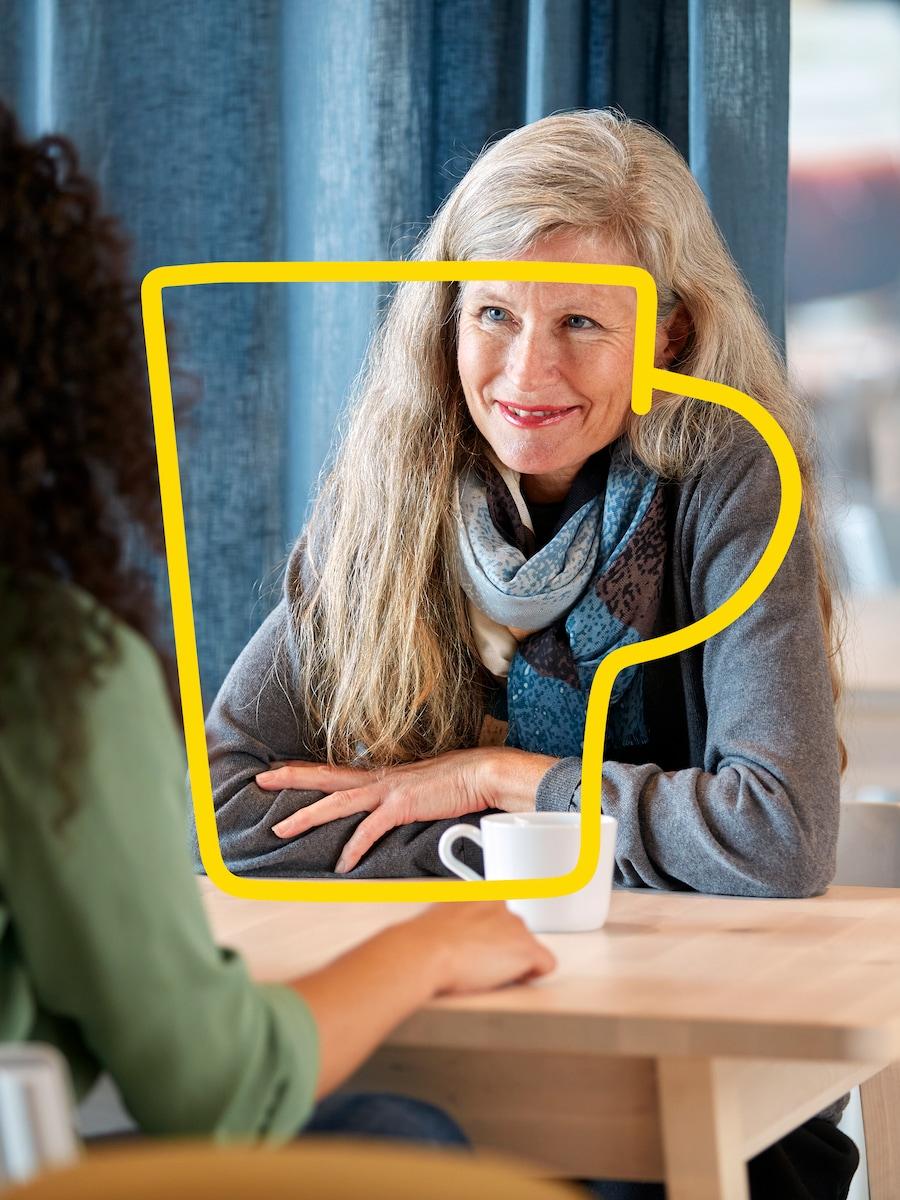 Two people drinking coffee in the IKEA restaurant.