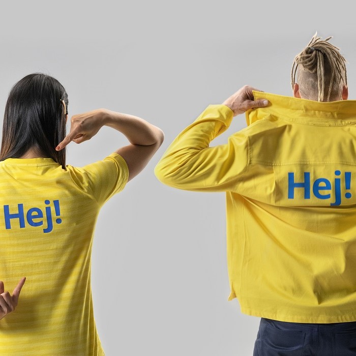 Two people in yellow IKEA uniforms