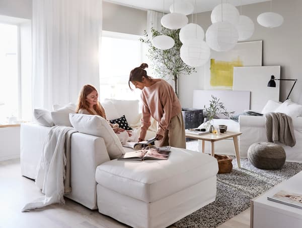 two people looking at catalogues and planning a home furnishing project.