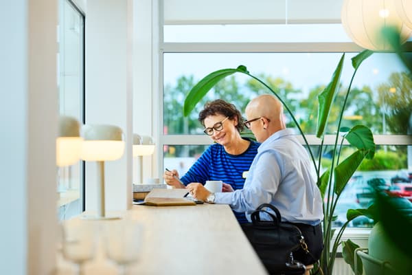 Two people sitting together and discussing IKEA finance options.