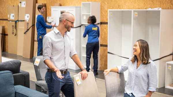 Two people smiling and shopping in IKEA As-Is department
